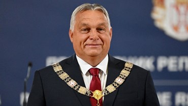 أوربان مبتسما بعدما قلده الرئيس الصربي ألكسندر فوتشيتش وسام الاستحقاق، خلال اجتماعهما في بلغراد (16 ايلول 2022، أ ف ب). 